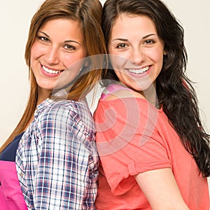 Happy sisters smiling and looking at camera
