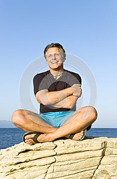 Happy sitting on a rock