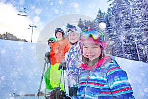 Happy ski girl with skiing class group portrait