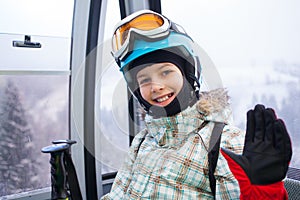Happy skier girl on ski lift.