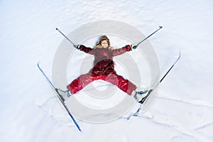 Happy skier laying as a star on the snow