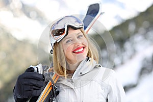 Happy skier looks at camera in the mountain