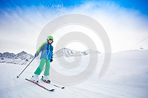 Happy skier sliding fast while skiing on slope