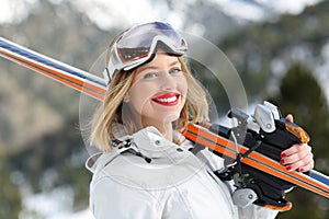 Happy skier ready to sky looking at camera