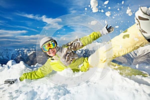 Happy skier woman jump in and throw snow