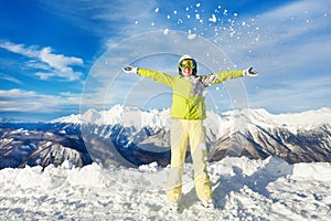 Happy skier woman throwing snow up