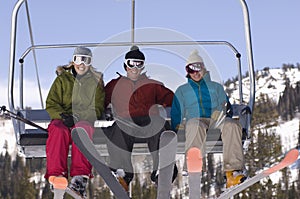 Happy Skiers On Chairlift