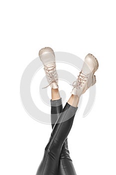 Close-up slender female legs in stylish boots isolated on white background