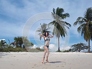 Happy slim young woman on the tropical bounty beach