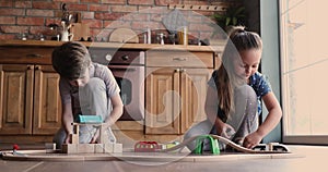 Happy small adorable children playing toys in kitchen.