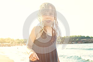 Happy small girl playing on sea beach