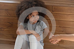 Happy small kid girl orphan holding hand of foster parent photo