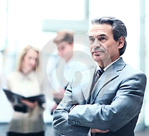 Happy smart business man with team mates discussing in the background in the office