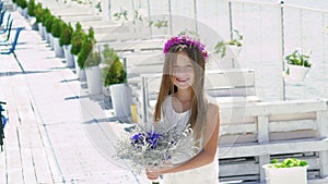 Happy smart girl admiring with flowers and smiling. Slowly