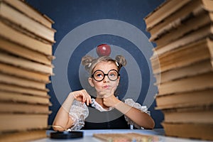 Happy smart girl in rounded glasses thoughtfully sitting between