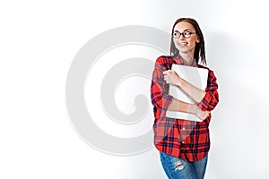 Happy smart young woman holding laptop