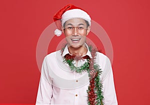 Happy smile asian businessman wearing Santa hat in christmas party  office on isolated over red background.Happy new year concept