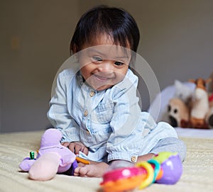 Happy, smile and baby with down syndrome playing with toys for child development in a bedroom. Happiness, learning and