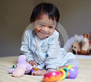 Happy, smile and baby with down syndrome playing with toys for child development in a bedroom. Happiness, learning and