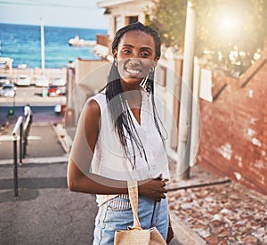 Happy smile black woman on vacation in city by sea or ocean water port side on sunshine summer holiday travel. Portrait