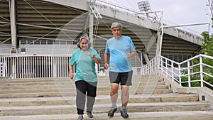 Happy and smile couples elderly asian running on stairs for workout, jogging on morning, senior exercise outdoors for good healthy