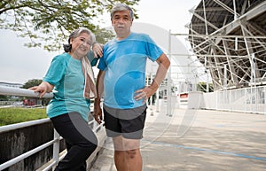 Happy and smile couples elderly asian standing on stairs for rest after workout, jogging on morning, senior exercise outdoor for