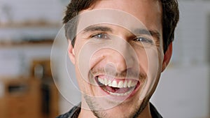 Happy, smile and a man laughing closeup at comedy, joke or good news in home. Comic, laugh and fun, a guy smiling with