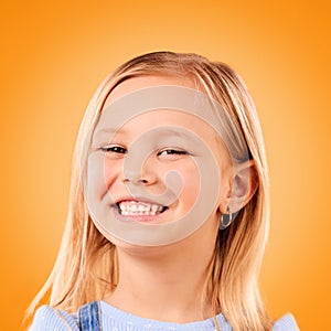Happy, smile and portrait of girl on orange background with happiness, joy and excited in studio. Canada, childhood and