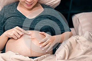 Happy smile pregnant asian woman touching her belly, Mother play with her baby, pregnancy, Maternity prenatal care and woman