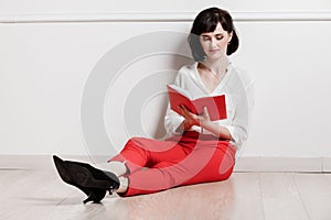 Happy smile young business woman holding and working with notebook and sitting on the floor at home office. Concept of