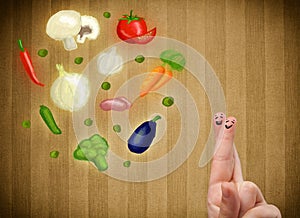 Happy smiley face fingers looking at illustration of colorful healthy vegetables