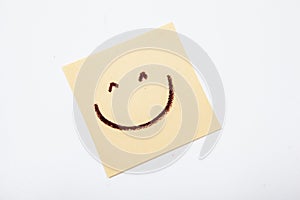 Happy smiley face on yellow sticky paper