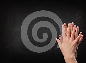 Happy smiley fingers looking at empty black chalboard