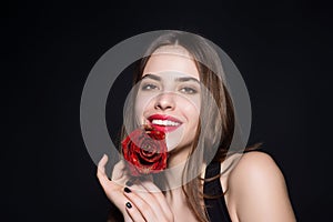 Happy smilig woman with flowers. Studio beauty portrait of young beautiful sexy woman with red rose flower.