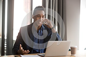 Happy smiling african american employee making call to client