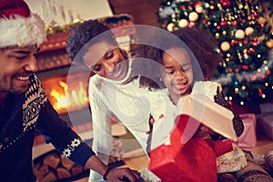 Happy smiling African American family in Christmas atmosphere