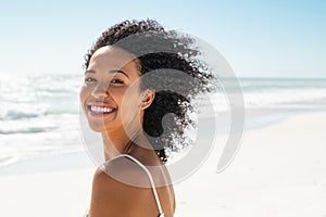 Happy smiling african american woman at beach