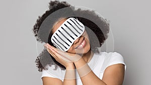 Happy smiling african american young lady put on eyemask. photo