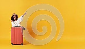 Happy smiling african woman dressed in summer clothes with luggage enjoying their summer vacation getaway in yellow banner