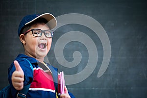Happy smiling asian boy in glasses with thumb up