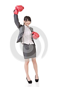 Happy smiling asian business woman with red boxing glove