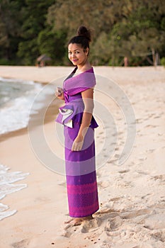 Happy Smiling Asian Girl in Traditional Dress on the Beach