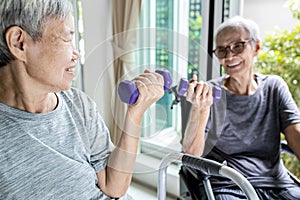 Happy smiling asian senior women exercising together,physical exercise activities by lifting weights,old elderly people with