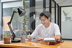Happy smiling asian student using digital tablet computer. Online learning education concept.