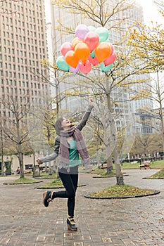 Happy smiling Asian woman holding balloons