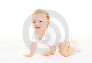 Happy smiling baby crawls on white background