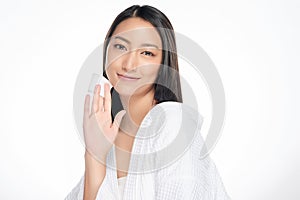 Happy smiling beautiful asian woman using cotton pad cleaning skin