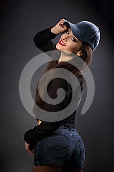 Happy smiling beautiful brunette woman in baseball blue cap with