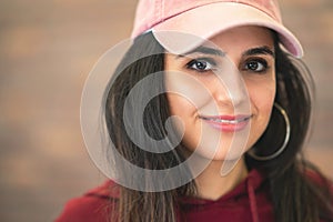Happy  Smiling Beautiful Brunette Woman In Baseball Pink Cap With Long Hair Style In Fashion