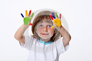 Happy smiling beautiful little girl with her colorful hands in the paint isolated on white background